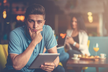 Young male using digital tablet in modern startup office