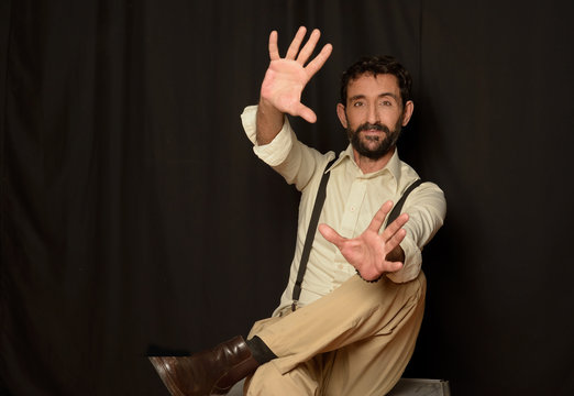 Adult elegant man outstretching hands forward