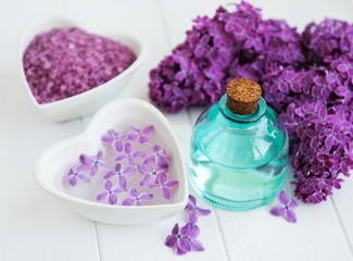 Plakat Essential oil and sea salt with lilac flowers