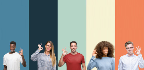 Group of people over vintage colors background smiling positive doing ok sign with hand and fingers. Successful expression.