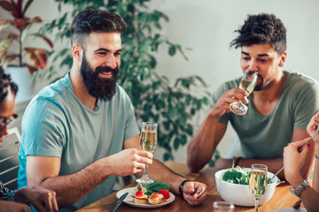 Group of multiethnic friends enjoying dinner party