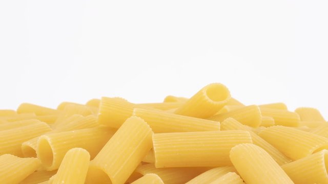 Italian fusilli pasta rotating on white background, copy-space (loopable)