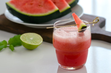 Watermelon smoothie  with lemon and mint to cool down on hot days. Refreshening fruit drink to lose weight.  Background with copy space.