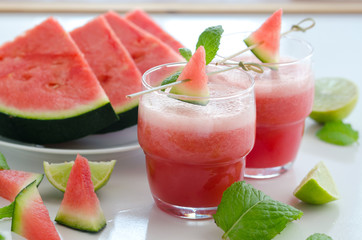 Watermelon smoothie  with lemon and mint to cool down on hot days. Refreshening fruit drink to lose weight.  Raw diet concept.