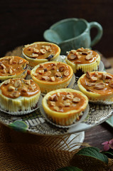 Cheesecake muffins with a caramel topping on a rustic plateau