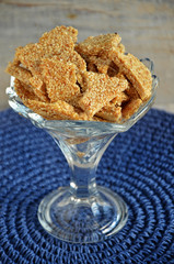 Sesame seed candy in a glass on a blue background