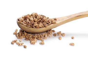 Organic barley flakes in wooden spoon isolated on white background