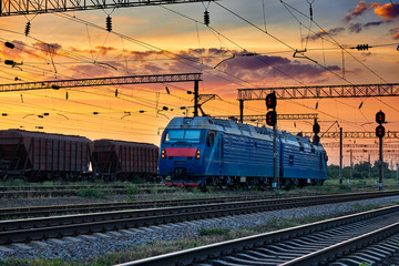 Fototapeta na wymiar trains and wagons, railroad infrastructure, beautiful sunset and colorful sky, transportation and industrial concept