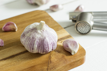 Garlic on wooden cutting board.
