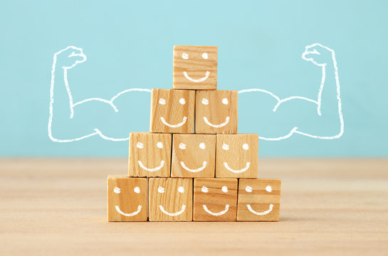 image of wooden blocks with people icons over table ,building a strong team, human resources and management concept.