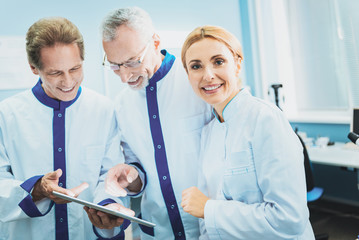 Fototapeta premium Join our team. Amazing woman wearing medical uniform, posing on camera