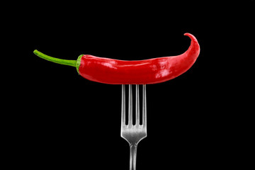 Fototapeta na wymiar glossy juicy hot chili pepper on a fork