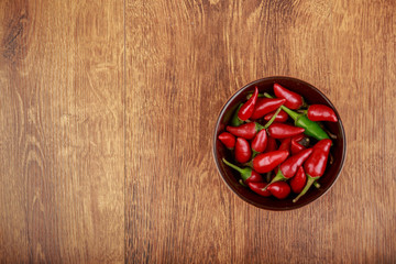 red chili pepper in bowl on wooden table