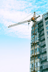 Fototapeta premium Construction crane against the building