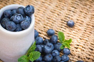 Blueberries. Freshly picked blueberry in ceramic bowl with berries and natural background. Blueberries are known to contain anitoxidant for nutrition health benefits