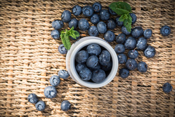 Blueberries. Freshly picked blueberry in ceramic bowl with berries and natural background. Blueberries are known to contain anitoxidant for nutrition health benefits