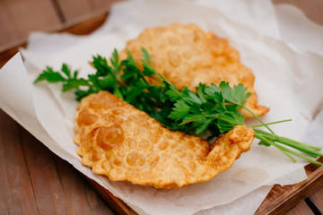 The Caucasian food is a patty made from thin unleavened dough with stuffed lamb and spicy seasonings. Cheburek - fried pie with meat and onions. Traditional dish of many tatar and eastern peoples.