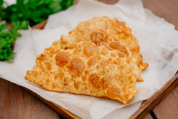 The Caucasian food is a patty made from thin unleavened dough with stuffed lamb and spicy seasonings. Cheburek - fried pie with meat and onions. Traditional dish of many tatar and eastern peoples.