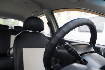 Steering wheel on the car dashboard and the driver's seat