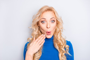 Naklejka premium Oops! Portrait of sexy, foxy, stylish, pretty, cute, charming, nice, blonde woman in blue roll neck holding palm near pout lips looking at camera isolated on grey background
