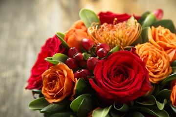 Winter or autumn bouquet with roses