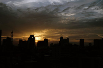 Fototapeta na wymiar Sunset over the city with clouds sky.