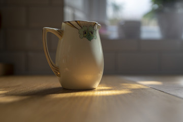 Small milk jug on wooden table