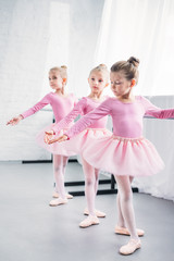 adorable little ballerinas practicing together in ballet studio