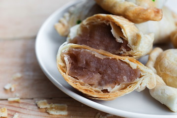 Bakery homemade,Curry puff with stuffed sweet potato on wooden desk.