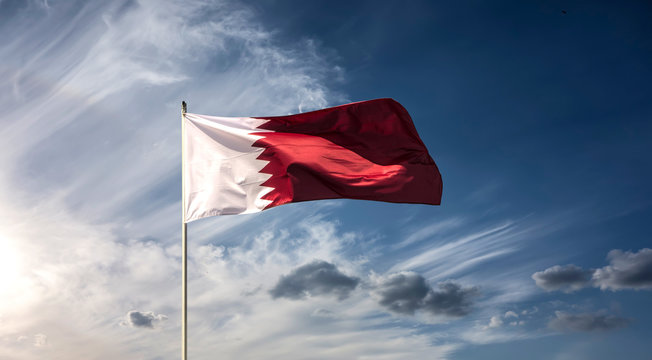 Flag of the country Qatar waving in the wind