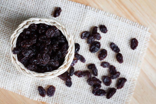 Dried raisin on basket weave on the desk, Top view.