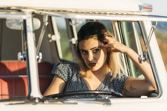 young woman inside old van