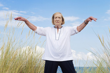 An old woman practicing Tai Chi