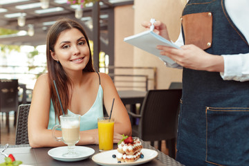 Waitress server helping client in cafe