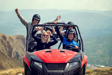 Friends driving off-road with quad bike or ATV and UTV vehicles