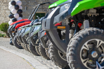 parked in a row several atv quad bikes extreme outdoor adventure concept © FS-Stock