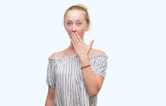 Blonde teenager woman wearing a bun cover mouth with hand shocked with shame for mistake, expression of fear, scared in silence, secret concept