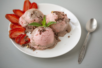 Chocolate and strawberry ice cream, with berries, sprinkled with chocolate