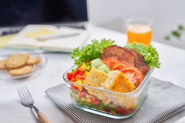 homemade lunch box at modern stylish work place, view from above
