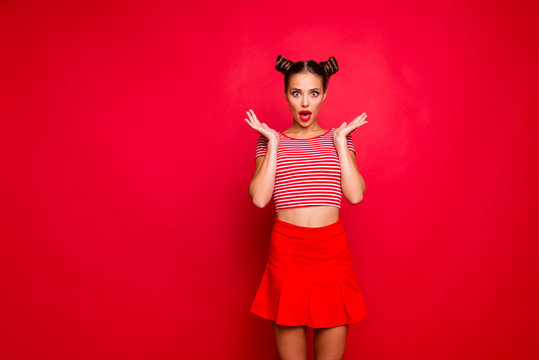 Sporty girl isolated on red background with copy space for text in red skirt and striped shirt impressed by good unexpected news! Concept of human feelings
