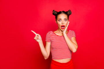 Fototapeta Look there! What a news! Attractive brunette girl with modern hairdo touch the cheek, having wide open mouth and brown eyes show finger on red background obraz