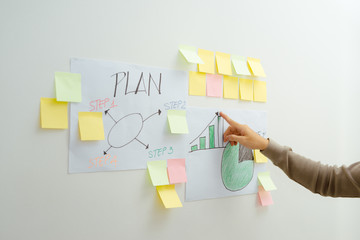 Brainstorming concept. Hipster man writing on post-it in office