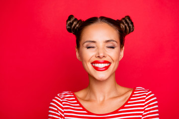 Close up the girl's face with a wide smile and blinked eyes with happiness isolated on red bright background