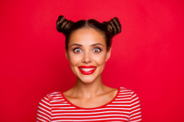 Closeup of happy face young girl with red lips and big brown eyes look at camera on red background