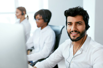 Call Center Operator With Colleagues At Workplace