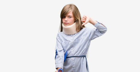 Young blonde child injured wearing neck collar and crutches with angry face, negative sign showing dislike with thumbs down, rejection concept