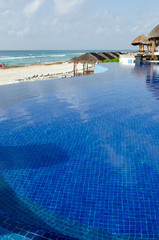 Infinity edge swiming pool. Summer, sand