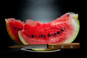 Slices of juicy watermelon shot close-up on a dark background