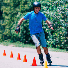 Senior man roller skating in park