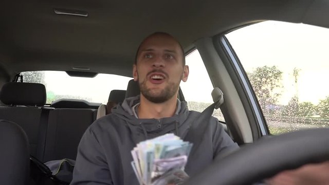 Happy driver with big money dollars. Success. Concept on the topic of lottery, winnings, slot machines, business success.